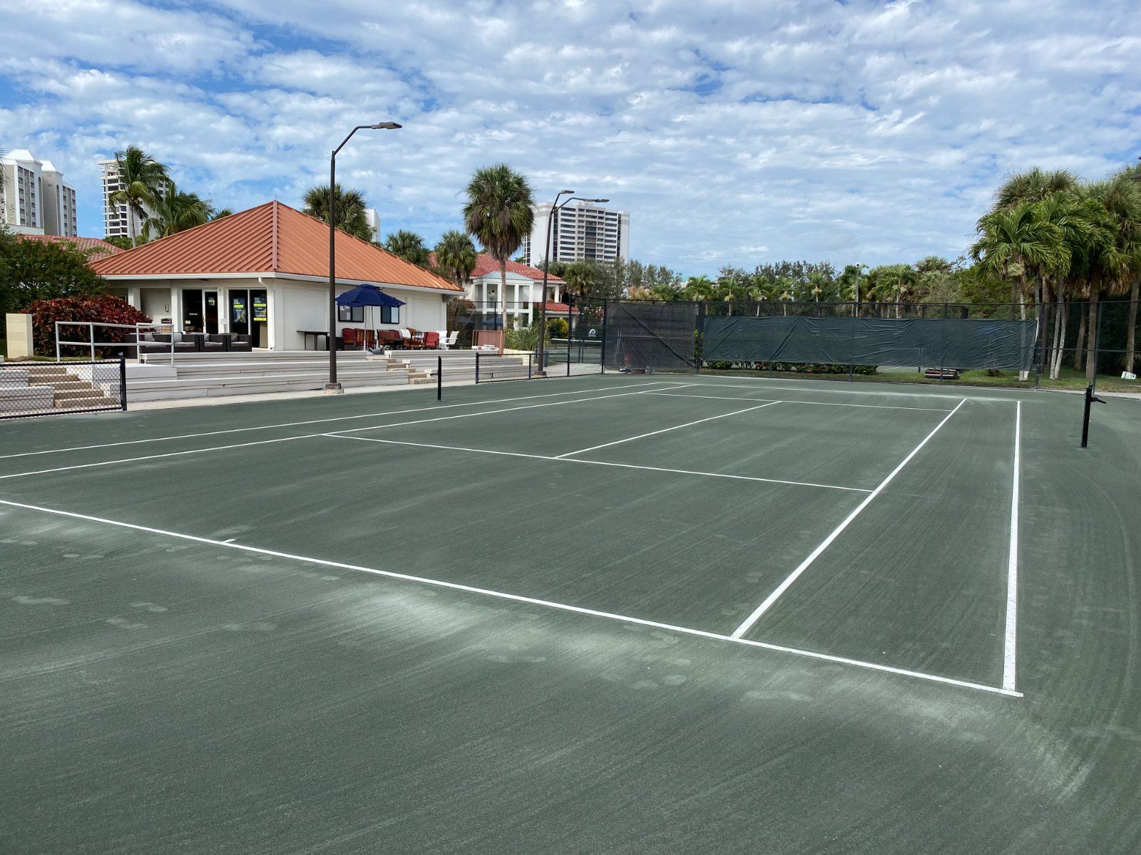 Tennis courts with clubhouse and palm trees in Florida